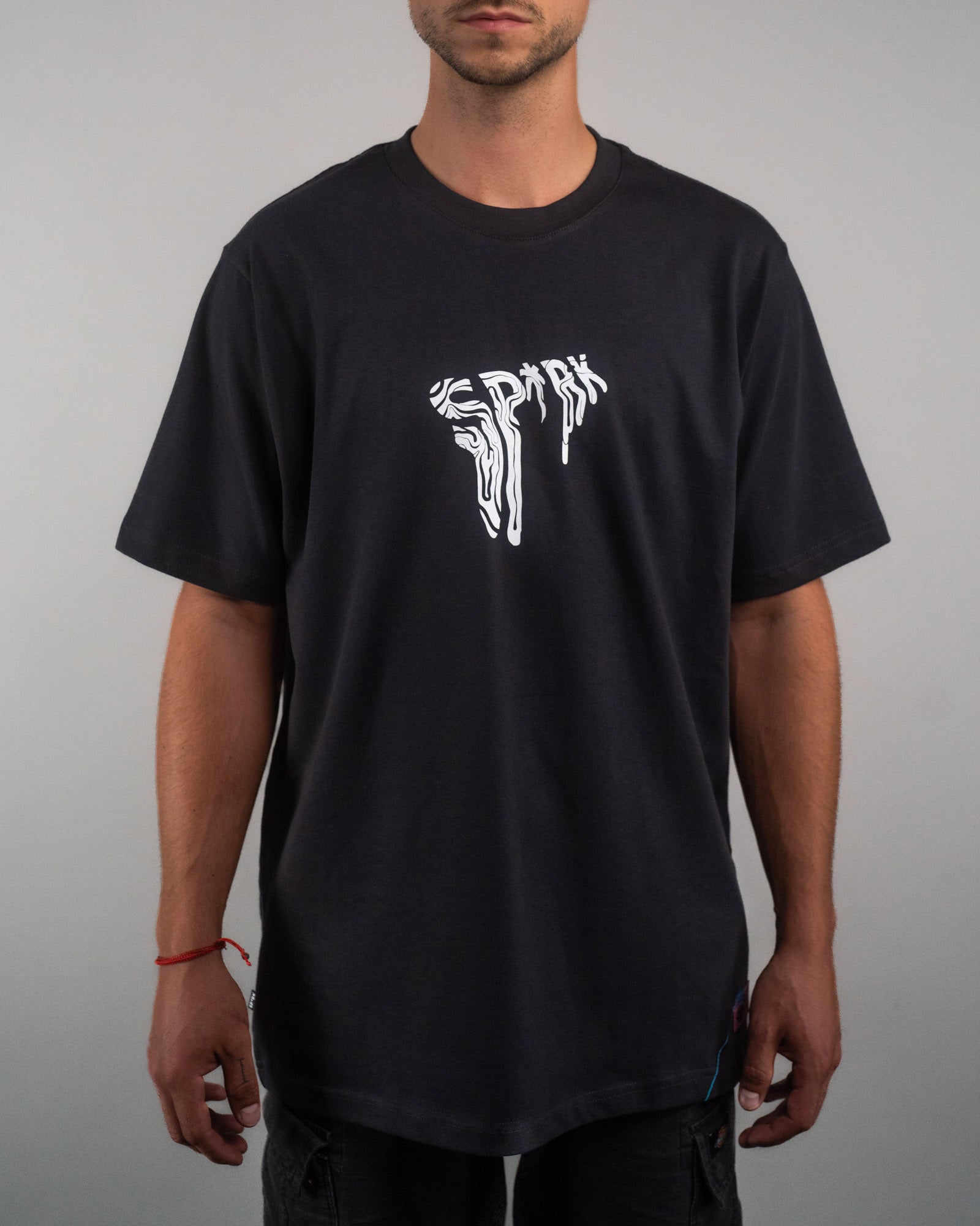 Frontalansicht eines schwarzen T-Shirts mit weißem, verzerrt-illustriertem „SPRK“-Schriftzug mittig auf der Brust. Der Schnitt ist locker und die Ärmel reichen knapp über die Ellenbogen.