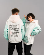 Beide Models in dynamischer Pose. Die Rückseite des linken Hoodies zeigt den „PARTY IN MY HEAD“-Print, der rechte Hoodie ist leicht seitlich gedreht und zeigt Vorderseite mit Tasche und bedrucktem Ärmel.