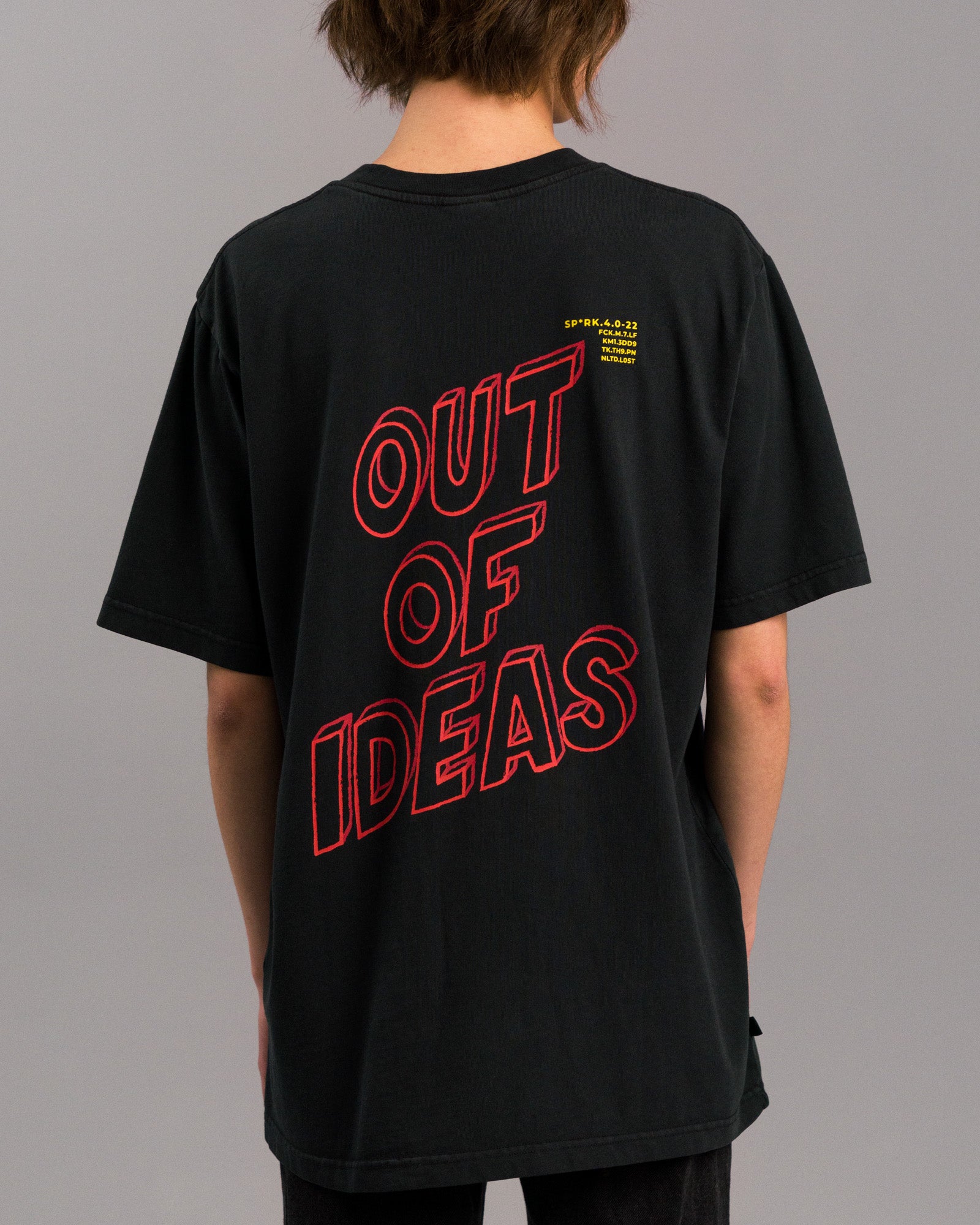 Rückansicht des schwarzen T-Shirts mit großem, rotem Backprint in 3D-Optik: „OUT OF IDEAS“ in Großbuchstaben sowie kleinem gelben Textfeld oben rechts.
